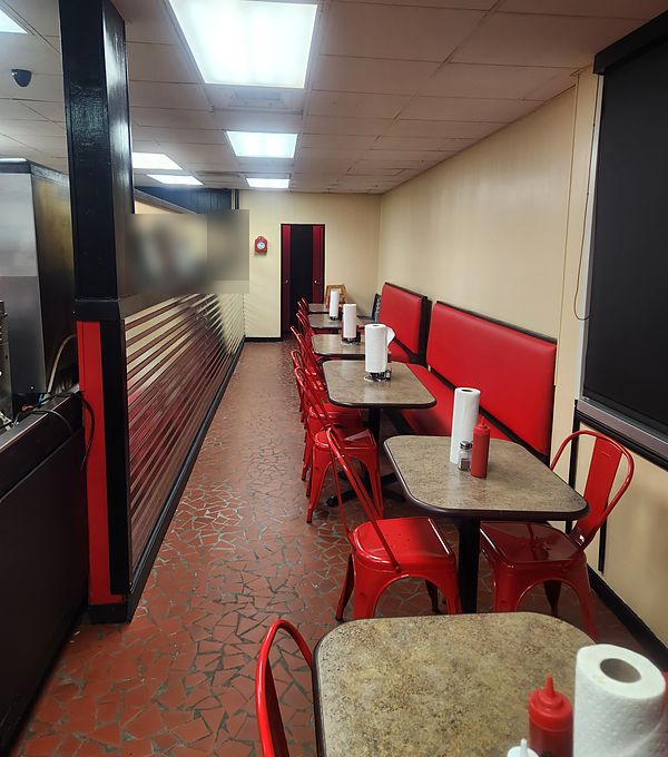 Red booths and red chairs lining the dining room at The Shack