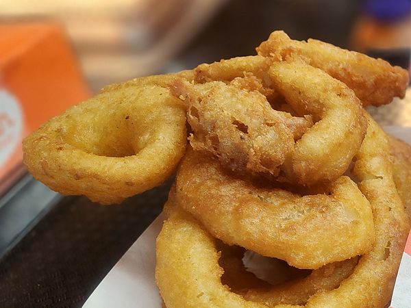 A basket of golden, crispy onion rings