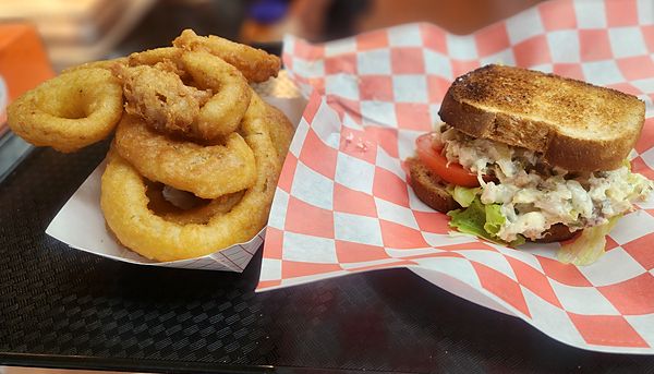 Golden onion rings and a sandwich on toasted bread